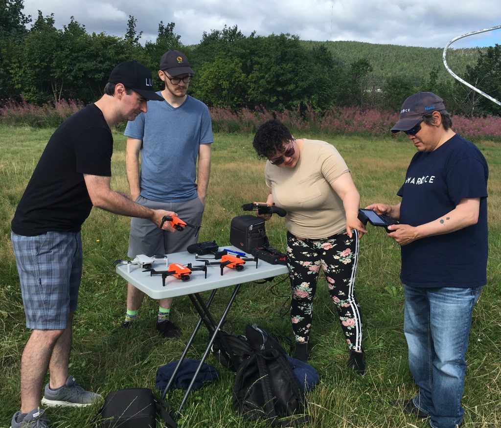 People undertaking training outside, grass, trees